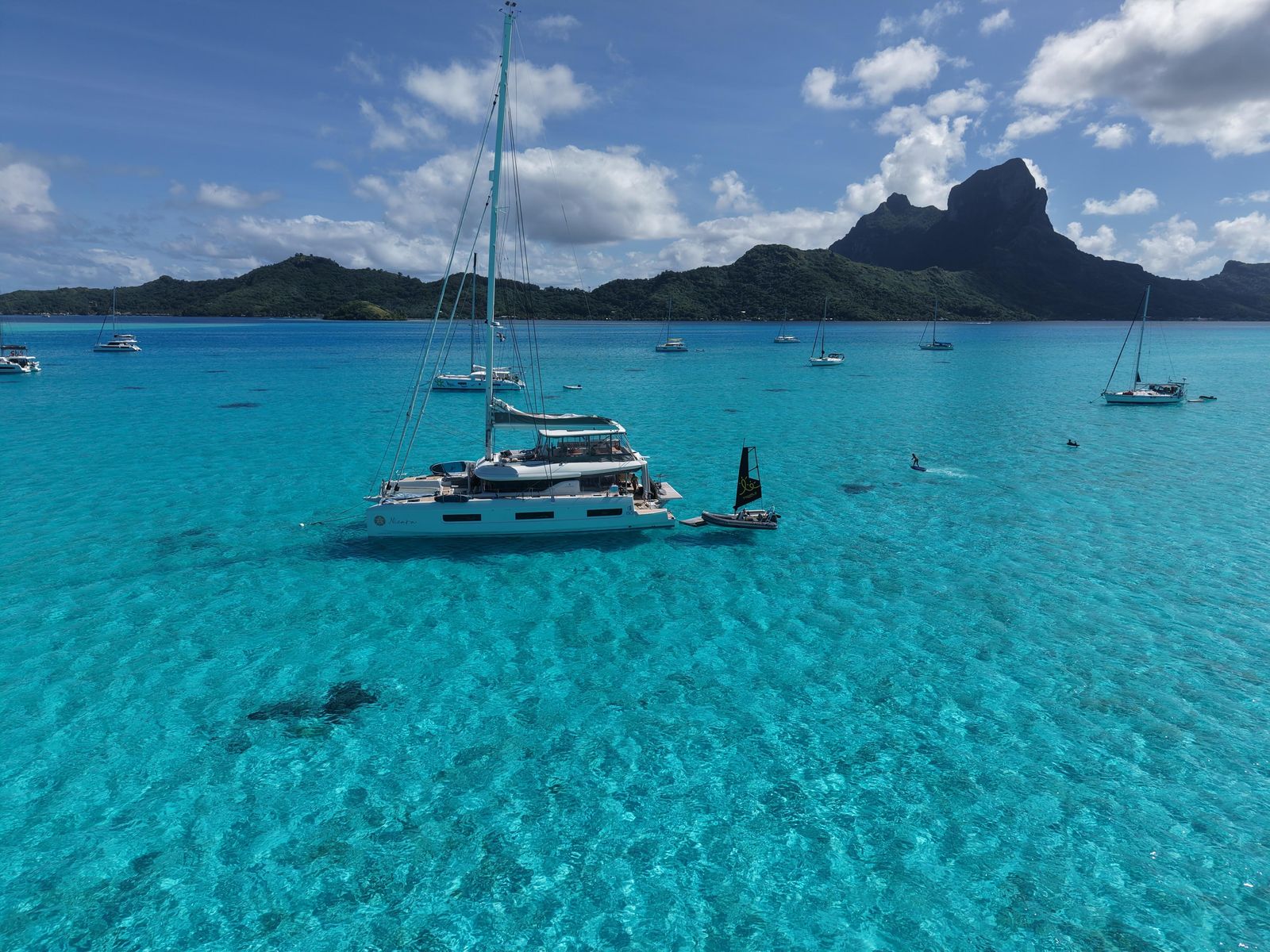 Foiling beside Nicara in a turquoise lagoon